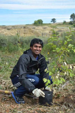 Youth volunteer with tree